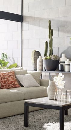 a living room filled with furniture and plants