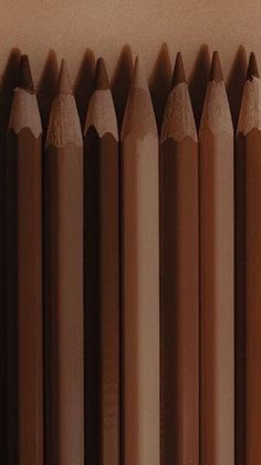 several brown pencils lined up next to each other