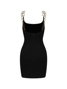 a black dress with gold chains on the shoulders