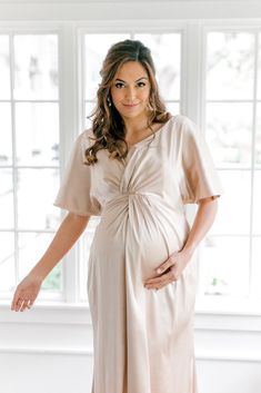 Our graceful Gwen Satin dress has been modified with a higher waistline and extra room to accommodate a growing bump, becoming the perfect option for the mommy-to-be in your bridal party! While a little more modest in coverage, the Gwen still features flutter sleeves and a delicate front twist detail that adds sophistication to a timeless design. FEATURES: Empire silhouette V-neckline Built-in bra cups and vertical boning for support Dolman flutter sleeves Back zipper Full-length double lining f Elegant Bump Friendly Spring Dresses, Elegant Spring Bump Friendly Dresses, Elegant Spring Dresses Bump Friendly, Elegant Spring Dresses, Bump Friendly, Elegant Spring Maternity Dress Bump Friendly, Elegant Maternity Dress Nursing Friendly, Elegant Nursing-friendly Maternity Dress, Maternity Empire Waist Ruched Dress, Elegant Spring Nursing Friendly Dresses