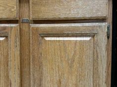 an open wooden door with two knobs on it