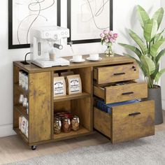 a wooden cabinet with two drawers and a sewing machine on top of it next to a potted plant