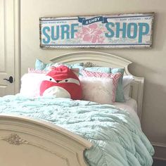 a bedroom with a surf shop sign above the bed