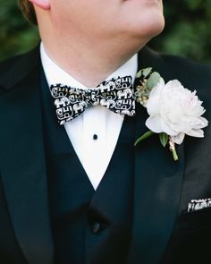 a man in a tuxedo with a flower on his lapel