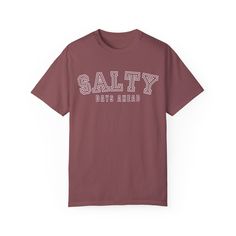 Get ready for endless beach days with the Eddy and Rita Women's Comfort Colors T-Shirt featuring the cheerful slogan "Salty Days Ahead." Made from premium Comfort Colors cotton, this t-shirt offers exceptional softness and durability, making it perfect for a day at the beach or a casual outing. Whether you're planning a seaside escape or simply dreaming of the ocean, this stylish graphic tee is designed to keep you feeling comfortable and looking great. Add this fun and relaxed tee to your wardr Beachy Cotton T-shirt With Text Print, Beachy Crew Neck T-shirt With Letter Print, Comfortable Loungewear, A Day At The Beach, Day At The Beach, Comfort Colors Tee, Everyday Activities, Beach Days, Beach Day