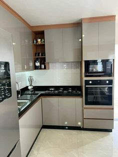 a modern kitchen with stainless steel appliances and cabinets