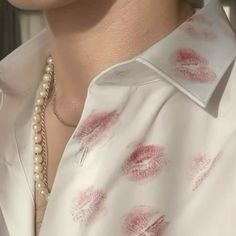 a close up of a woman's shirt with lipstick prints on it