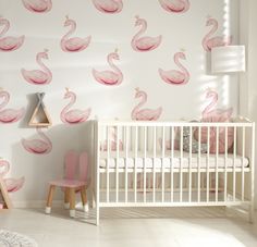 a baby's room with pink flamingos on the wall