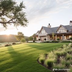 a large house sitting on top of a lush green field