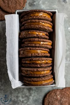 a box filled with cookies covered in frosting on top of a gray countertop