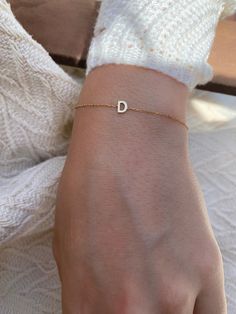 Add a personal touch with this dainty initial bracelet.DETAILS- Crafted with 14k solid gold- Chain style may vary slightly- Handmade in our New York City studioDIMENSIONS- Dimensions will vary depending on the letter- Bracelets are available in 6", 7", and 8" with 1/2" adjustable loopsPERSONALIZATIONhe letter you would like on the necklace. Please capitalize or use lower case according to your preference. VARIATIONSIf you require any variation of this style (smaller or larger nameplate, longer c