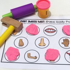 the parts of a body are shown in pink and purple doughnuts on top of a sheet of paper