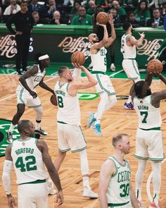 the boston bucks are playing basketball in front of an empty court with fans watching them