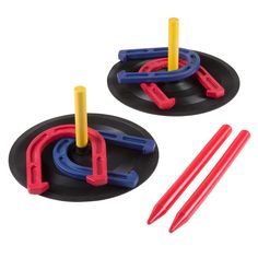 two plastic toys on top of black discs with yellow and red handles, one blue and the other red