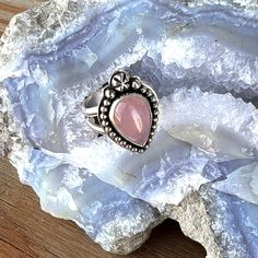 Sweet Rose Quartz Ring with sterling silver accents. This yummy teardrop shaped ring will give your day a a pink pop of color! It set in sterling silver with a fine silver bezel.  The genuine gemstone is surrounded by bead wire and accented with 3 handmade sterling silver balls.  The solid backing is stamped with my starfish logo and .925 for authenticity.   The setting is 3/4 X 1  inch and sits atop a split band, made for comfort and style.  Small enough to wear eery day, but large enough to make a statement. Hand made in my Arizona studio, all of my jewelry is designed and created by me using sterling silver and a torch. This beauty will arrive in one of my signature teal gift boxes, perfect for storing or gift giving made easy.  Made and ready to ship for free. Starfish Logo, Bead Wire, Rose Quartz Ring, Quartz Ring, Silver Accents, Handmade Sterling Silver, Fine Silver, Gift Boxes, A A