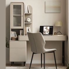 a white chair sitting in front of a desk with a laptop computer on top of it