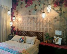 a bed room with a neatly made bed and flowers on the wall