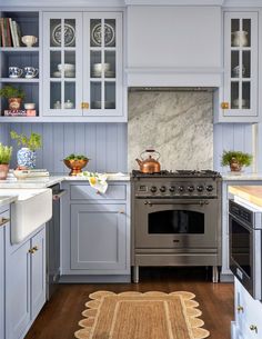 a kitchen with blue cabinets and an oven