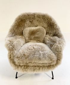 a chair made out of fur and metal legs