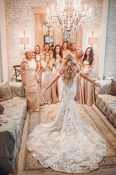 the bride and her bridal party pose for a photo in front of their couches