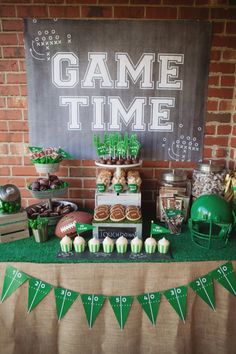 a game time dessert table with green and white decorations on it's tablescape