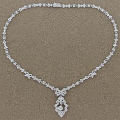 For Sale on 1stDibs - A feminine necklace made in Edwardian style featuring a 0.54 carat round cut diamond drop. The ribbons and bows of this platinum necklace are studded with Elegant Platinum Diamond Necklace With Baguette Diamonds, Elegant Formal Diamond Necklace With Baguette Diamonds, Vintage Diamond Necklace, Victorian Pendant Necklace, Platinum Necklace, Art Deco Pendant Necklace, Feminine Necklace, Victorian Pendants, Art Deco Brooch