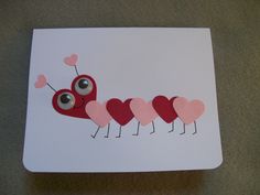 a card with hearts shaped like a caterpillar on the front and eyes in the back