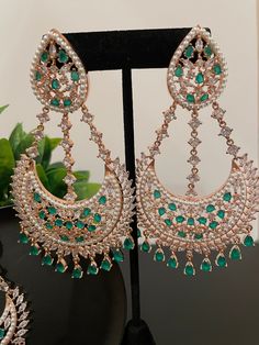 This maangtikka set comes with matching statement earrings and is beautiful and elegant for any occasion. The design is unique and oversized and it comes in two colors with a beautiful finish. No need to wear any neckpiece with these as they are a statement jewelry by itself! Green Chandbali Chandelier Earrings For Party, Green Hand-set Chandbalis For Party, Heavy Chandelier Earrings For Eid Party, Green Chandbali Jewelry Sets For Party, Elegant Chandelier Earrings With Stone Work For Eid, Elegant Green Chandbalis For Eid, Elegant Heavy Green Chandbalis, Diwali Party Hand Set Chandelier Earrings, Elegant Green Tikka For Parties