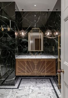 a bathroom with black marble and gold accents