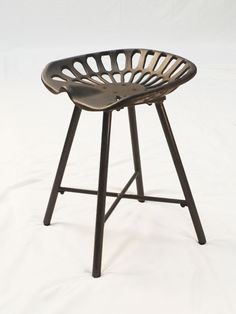 a metal stool with a wooden seat on it's legs and backrests