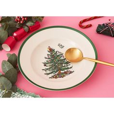 a plate with a christmas tree on it and a gold spoon in front of it