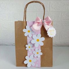 a brown paper bag with pink and white flowers on it