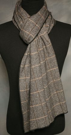 This brown, black and beige plaid scarf is long and perfect for the man or woman. It is of a heavier weight. Just right for the cold winter months. Dress it up or dress it down. When I first saw this fabric I fell in love with it. I finish my scarves with a machine decorative flat hem. I shop for very fine fabrics and this fits the bill. Be nice to your scarves and they will last a long, long time.  Enjoy the scarf and wear it with confidence!! 100% Fine Wool   Measures approx.:   94L  15W ins. Classic Beige Scarves For Fall, Classic Beige Scarf For Fall, Classic Plaid Scarves For Fall, Classic Business Scarves For Fall, Classic Fall Business Scarves, Black Wool Scarves For Fall, Classic Black Scarf For Fall, Classic Plaid Scarves For Winter, Mens Winter Scarf