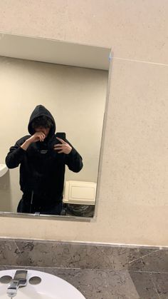 a person taking a selfie in front of a bathroom mirror with the reflection of them