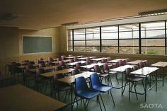 an empty classroom with desks and chairs