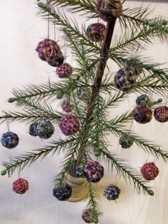 a pine tree with ornaments hanging from it's branches