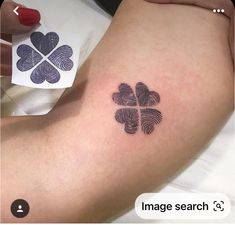 a woman's foot with a four leaf clover tattoo on it