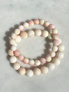 Gorgeous all-natural Queen Conch Shell beads in 8mm and 10mm size on comfortable stretch string. These shells are peachy pink and have a beautiful natural luster to them. Select your size from the drop down, or message me if you require a different size, as I'm always happy to accommodate if I'm able. To measure your wrist size, use a piece of string or flexible measuring tape and wrap around the wrist just above the bone. For non-adjustable and stretch bracelets, allow 1/2 - 1 inch more than your wrist measurement - more for larger stones (8mm or larger), and less for smaller stones (4mm or smaller), as larger stones will reduce the circumference of the closed bracelet. Another way to know your preferred size is to find a bracelet you own that you like the fit of and measure it for your i Queen Conch Shell, Conch Shell, Shell Jewelry, The Bone, Measuring Tape, Peachy Pink, Shell Beads, Conch, Stretch Bracelet