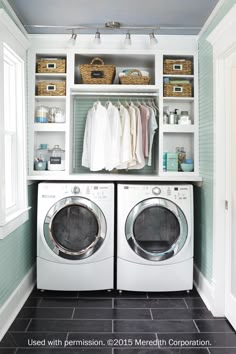 a washer and dryer in a laundry room with shelves on the wall above them