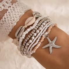 Embrace the carefree spirit of summer with the Ocona Bohemian Shell & Starfish Beaded Bracelet Set. This stunning 7-piece set features intricately woven rice beads, delicate shell accents, and starfish charms, capturing the essence of beach resort style. Perfect for layering or wearing individually, each bracelet is designed to add a touch of boho-chic elegance to any outfit. Whether you're strolling by the shore or adding a coastal vibe to your everyday look, this versatile set is the ideal acc Beachy Bracelets, Bead Woven Bracelet, Seashell Bracelet, Starfish Bracelet, Vintage Bohemian Style, Starfish Pendant, Beach Bracelets, Rice Bead, Shell Bracelet