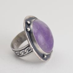 "This all sterling silver ring features a round amethyst, set on a recycled silver backplate, studded with small silver balls. The ring shank is about 8mm wide. The face of the ring is about 1.25\" x 1.25\" across. The ring has been oxidized and selectively brushed to highlight the details. The ring is US size 8.5. It can be enlarged on request in quarter sizes up to 9.5. Because of the width of the band, I'd suggest ordering a size 1/4 to 1/2 larger than normal. Please read my shipping and poli Adjustable Silver Amethyst Ring With Stone Setting, Sterling Silver Purple Ring With Large Stone, Vintage Sterling Silver Amethyst Ring With Stone Setting, Vintage Amethyst Sterling Silver Ring, Adjustable Hallmarked Silver Amethyst Ring, Silver Domed Rings With Gemstones, Nickel-free Silver Amethyst Ring In Sterling Silver, Adjustable Silver Amethyst Ring In Sterling Silver, Silver Amethyst Ring With Stone Setting