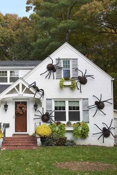 a white house decorated for halloween with spider decorations