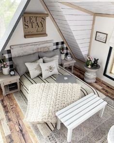 an attic bedroom is decorated in white and gray