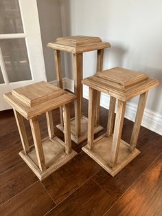 three wooden tables sitting on top of a hard wood floor