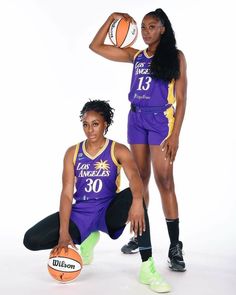 two women are posing with basketballs in their hands