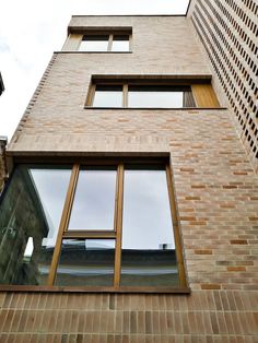 a tall brick building with two windows on each side