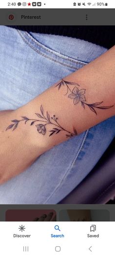 a woman's arm with flowers and leaves tattooed on the left side of her arm