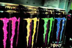 six cans of monster energy drink with neon colors