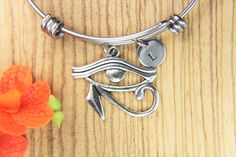 "♥ Eye of Horus Bangle Eye of Horus Bracelet Egyptian Pendant Eye of Horus Gift Personalized Bracelet Expandable Bangle Initial Bracelet ♥ This is a silver-tone Eye of Horus charm with hand stamped initial charm on an expandable bangle ♥ You will receive 1 bangle ♥ Eye of Horus charm 33(12/8\")x(26(1\")mm. ♥ Initial charm stainless steel 10mm choose from a drop-down menu. ♥ Bangle 57-64 mm ♥ additional initial https://www.etsy.com/listing/766732811 ♥ We strive for next day shipping, but we do no Symbolic Adjustable Charm Bracelet As Gift, Symbolic Adjustable Charm Bracelet For Gifts, Silver Bangle With Charms As Gift, Symbolic Stainless Steel Bracelet For Gifts, Adjustable Charms Bangle For Gift, Adjustable Charm Bangle With Lobster Clasp, Adjustable Metal Charm Bracelet As Gift, Adjustable Charms Bangle, Adjustable Stainless Steel Charm Bracelets