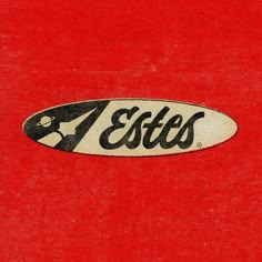 an old logo on the side of a red t - shirt that says esttes